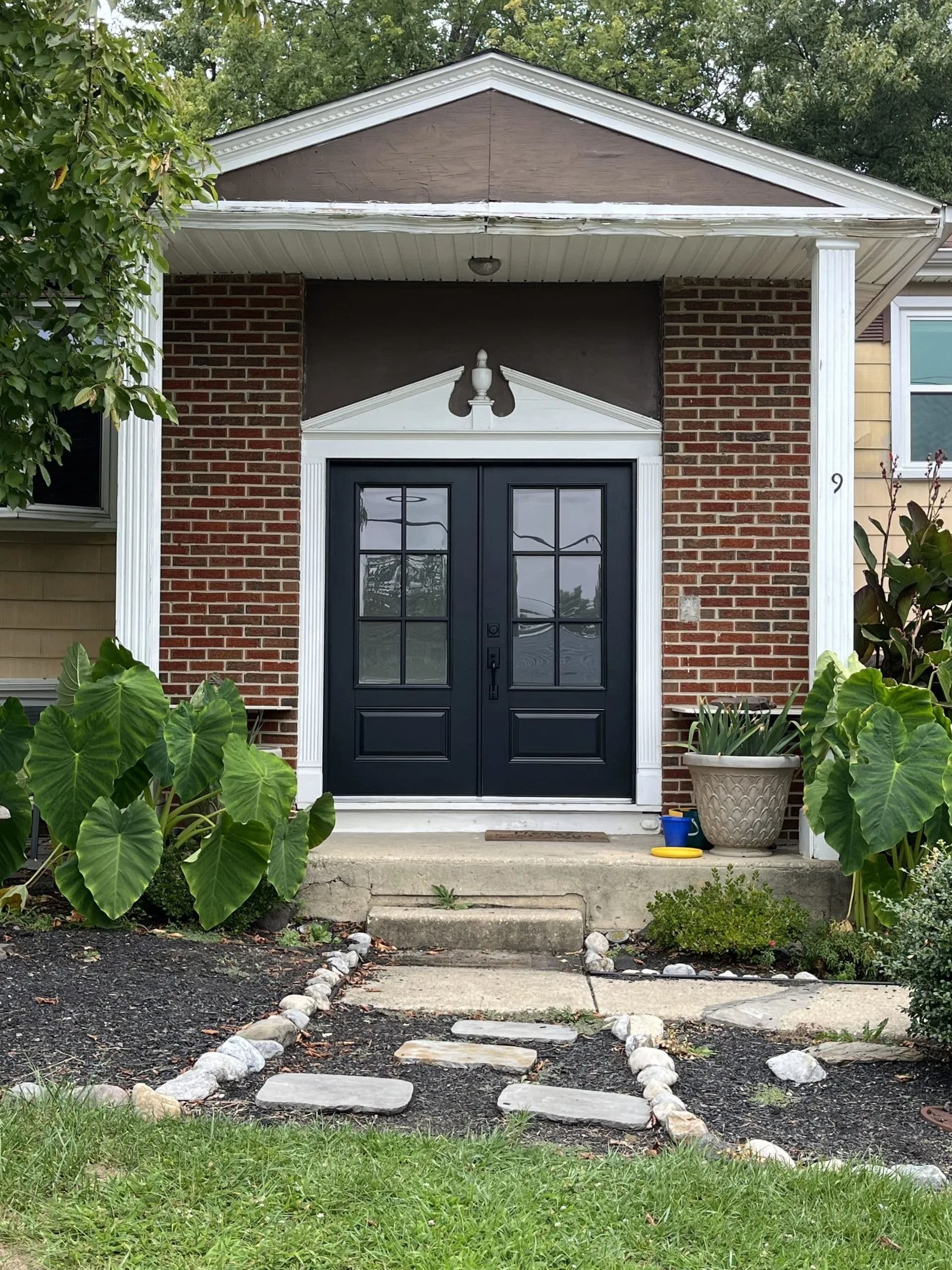 Front of the house showing a front door with bricks around it